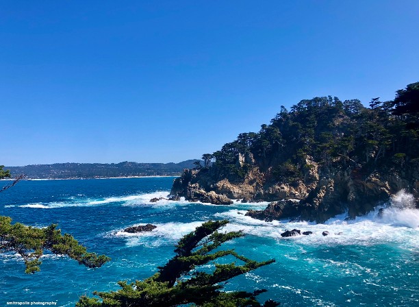 Breathtaking coastal view of Point Lobos State Natural Reserve, showcasing rugged cliffs, crashing waves, and turquoise waters along the Pacific Ocean, a must-see destination on guided walking tours in Monterey and Carmel.